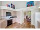 Bright, airy kitchen with neutral cabinetry, terracotta tile flooring, and open access to the dining area at 3388 Highlands Bridge Rd, Sarasota, FL 34235