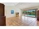Bright living room showcasing tile floors, high ceilings, and large sliding glass doors to the outdoor patio at 3388 Highlands Bridge Rd, Sarasota, FL 34235