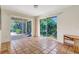 Light-filled living room featuring tile flooring and sliding glass doors to outdoor space at 3388 Highlands Bridge Rd, Sarasota, FL 34235