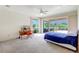 Bright main bedroom with a large sliding glass door, views to the outdoors, and carpet flooring at 3388 Highlands Bridge Rd, Sarasota, FL 34235