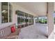 Covered patio with a bench, offering seamless indoor-outdoor living with sliding glass doors and views of a pool and yard at 3388 Highlands Bridge Rd, Sarasota, FL 34235