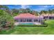 Backyard view of a screened in pool area, surrounded by lush greenery and hedges for enhanced privacy at 3388 Highlands Bridge Rd, Sarasota, FL 34235