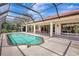 A gorgeous screened-in pool with an attached patio overlooking the landscaped back yard at 3388 Highlands Bridge Rd, Sarasota, FL 34235
