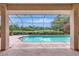 Enjoy the outdoors from this screened pool overlooking the lush greenery of the golf course at 3388 Highlands Bridge Rd, Sarasota, FL 34235