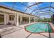 Large screened-in pool area featuring a spacious patio, perfect for lounging and enjoying the outdoors year-round at 3388 Highlands Bridge Rd, Sarasota, FL 34235