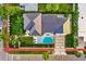 Aerial view of the home with a pool, lush landscaping, and a multi-angled roof at 340 Jackson Dr, Sarasota, FL 34236