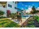 Stunning backyard featuring a modern pool, garden, patio seating, and meticulously landscaped gardens at 340 Jackson Dr, Sarasota, FL 34236