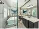This bathroom offers a walk-in shower with glass door, a soaking tub, double sinks, and modern fixtures at 340 Jackson Dr, Sarasota, FL 34236