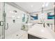 This bright and stylish bathroom offers a walk-in shower with glass door, a soaking tub, double sinks, and modern fixtures at 340 Jackson Dr, Sarasota, FL 34236