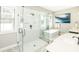 The stylish bathroom features a walk-in shower, a soaking tub, double sinks, and bright natural light at 340 Jackson Dr, Sarasota, FL 34236