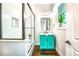 Bright bathroom with a vibrant turquoise vanity, white subway tiles, and a shower with a glass door at 340 Jackson Dr, Sarasota, FL 34236