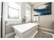 This bright and stylish bathroom offers a soaking tub, modern fixtures, and large windows that let in plenty of natural light at 340 Jackson Dr, Sarasota, FL 34236
