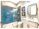 Modern bathroom featuring blue subway tiles in the glass-enclosed shower and mosaic tile flooring at 340 Jackson Dr, Sarasota, FL 34236