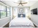 Bright bedroom featuring a queen-size bed, wood flooring, and a ceiling fan at 340 Jackson Dr, Sarasota, FL 34236