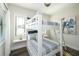 A bedroom with twin over full bunk beds, wood flooring, and white ladders at 340 Jackson Dr, Sarasota, FL 34236