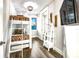 Charming bunk room with custom built-in bunk beds, stylish decor, and wood-look tile flooring at 340 Jackson Dr, Sarasota, FL 34236