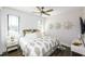 Bright bedroom with a ceiling fan, two windows, and a bed with a decorative patterned cover at 340 Jackson Dr, Sarasota, FL 34236