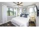 Sunny bedroom featuring hardwood floors, a ceiling fan, and two large windows at 340 Jackson Dr, Sarasota, FL 34236