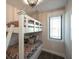 A bedroom with twin over full bunk beds, wood flooring, and stylish light fixture at 340 Jackson Dr, Sarasota, FL 34236