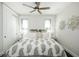 Calming bedroom with a ceiling fan, two windows, and a bed with a decorative patterned cover at 340 Jackson Dr, Sarasota, FL 34236