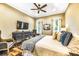 A cozy bedroom with a ceiling fan, TV, neutral tones, and wood-look flooring at 340 Jackson Dr, Sarasota, FL 34236