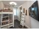 A bedroom with twin over full bunk beds, wood flooring, and mounted TV at 340 Jackson Dr, Sarasota, FL 34236
