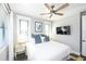 Bright bedroom featuring a queen-size bed, wood flooring, and a ceiling fan at 340 Jackson Dr, Sarasota, FL 34236