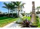 Exterior view showcasing a landscaped lawn, palm trees, and a glimpse of the swimming pool at 340 Jackson Dr, Sarasota, FL 34236