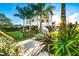 Gorgeous exterior featuring lush landscaping, palm trees, walkway, and beautiful architectural details at 340 Jackson Dr, Sarasota, FL 34236