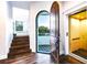 Stunning foyer with wood floors, an open front door, staircase, and a private elevator at 340 Jackson Dr, Sarasota, FL 34236