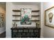 Stylish hallway with decorative art, floating shelves, and an elegant console table at 340 Jackson Dr, Sarasota, FL 34236