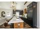 Kitchen featuring dark cabinets, stainless appliances, and an island with bar seating, and modern backsplash at 340 Jackson Dr, Sarasota, FL 34236