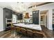 Kitchen with an island, stainless steel appliances, ample cabinetry, and stylish lighting fixtures at 340 Jackson Dr, Sarasota, FL 34236