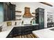 Detailed kitchen with stainless appliances, dark cabinets, and elegant counter tops and backsplash at 340 Jackson Dr, Sarasota, FL 34236