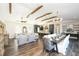 Open concept with hardwood floors, decorative ceiling beams, and kitchen and dining areas at 340 Jackson Dr, Sarasota, FL 34236