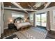 The main bedroom features a decorative wood ceiling, stylish carpet, and sliding glass doors to a balcony at 340 Jackson Dr, Sarasota, FL 34236