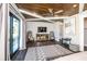 The main bedroom features a decorative wood ceiling, a ceiling fan, dark wood floors, and a comfortable sitting area at 340 Jackson Dr, Sarasota, FL 34236