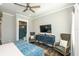 Cozy main bedroom featuring a ceiling fan, ensuite bathroom with blue tiled shower at 340 Jackson Dr, Sarasota, FL 34236