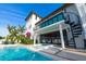 Relaxing backyard oasis with a private pool, spa, outdoor kitchen and bar, and nearby seating at 340 Jackson Dr, Sarasota, FL 34236