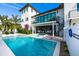Beautiful pool area with a connecting hot tub, spiral staircase and a covered patio at 340 Jackson Dr, Sarasota, FL 34236