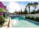 Beautiful private pool with waterfall feature and lush tropical landscaping surrounded by privacy fence at 340 Jackson Dr, Sarasota, FL 34236