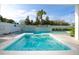 Stunning pool featuring a waterfall wall and lush landscaping, ideal for relaxation at 340 Jackson Dr, Sarasota, FL 34236