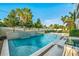 Beautiful backyard pool with lush landscaping and serene waterfall feature for relaxation at 340 Jackson Dr, Sarasota, FL 34236