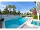 Inviting pool and hot tub surrounded by palm trees and manicured landscaping for outdoor enjoyment at 340 Jackson Dr, Sarasota, FL 34236
