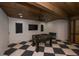 Recreation room with a foosball table, TV, and a striking checkered floor and wood ceiling at 340 Jackson Dr, Sarasota, FL 34236