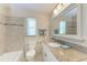 Well-lit bathroom features a granite vanity and mosaic tile accents around the bathtub at 3707 Kingswood Dr, Sarasota, FL 34232