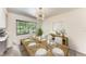 Dining room with modern lighting and a wooden table set for a dinner at 3707 Kingswood Dr, Sarasota, FL 34232