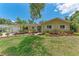 Charming single-story home with well-maintained lawn, lush tropical landscaping, and inviting curb appeal at 3707 Kingswood Dr, Sarasota, FL 34232