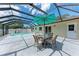 Enclosed patio with pool, patio furniture, and a serene outdoor space at 3707 Kingswood Dr, Sarasota, FL 34232