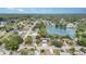 An aerial view showcasing a lake community surrounded by lush, mature trees at 3921 Marlborough Pl, Sarasota, FL 34241